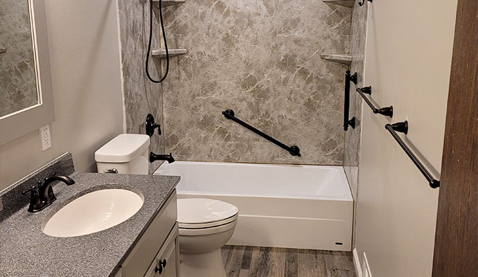 Accessible bathroom with bathtub and grab bars