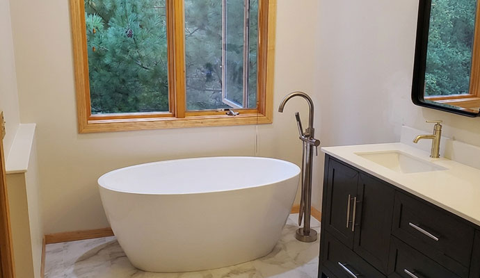 A clean modern bathroom with a freestanding tub