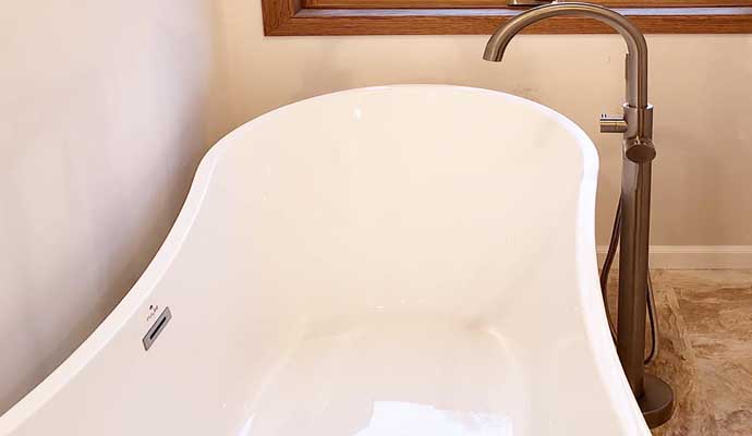 A sleek, white freestanding bathtub