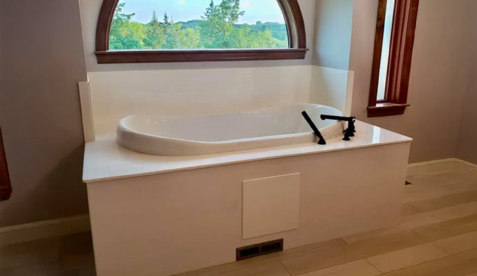 A sparkling clean bathtub in a modern bathroom