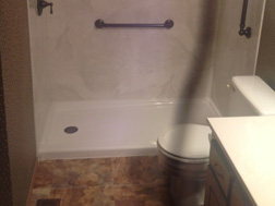 AFTER - The beautiful solid-surface acrylic Bath Planet Smooth Silver White Marble surround with White Shower Base. All of the fixtures are Oil Rubbed Bronze including the curved shower rod