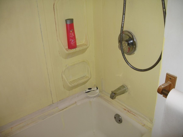 BEFORE - Dated shower surround needed to be replaced.