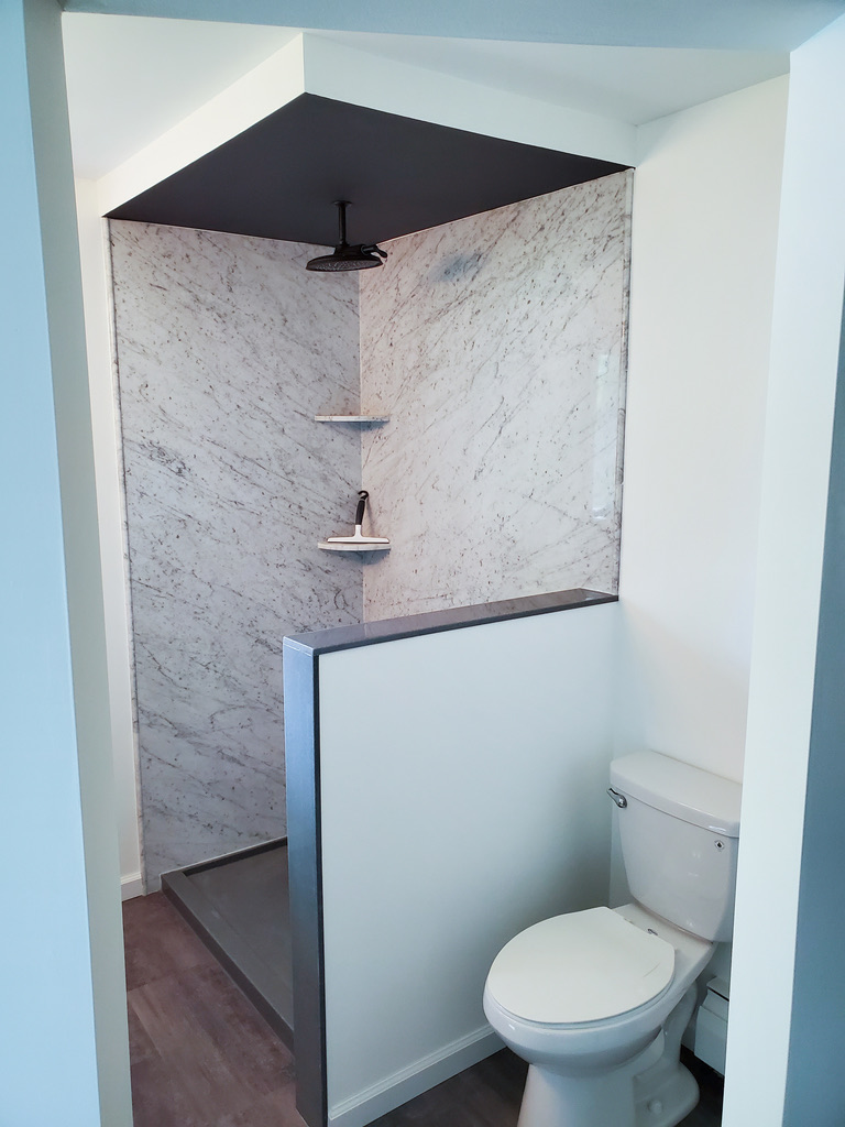 Re-Bath white cararra natural stone walk-in shower