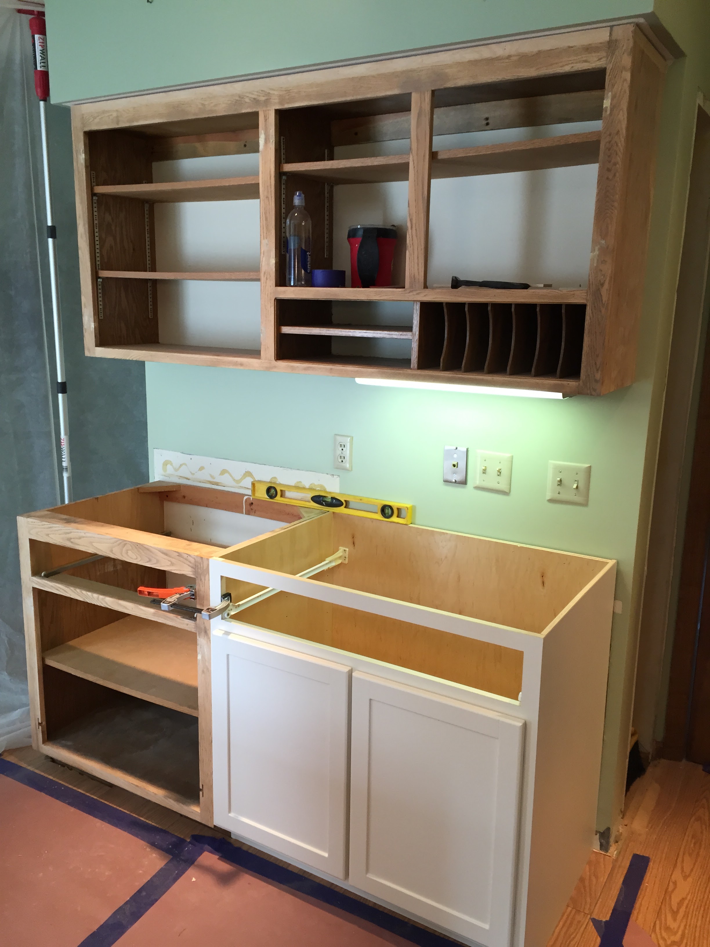 DURING - New Cabinets are installed to make the area more functional with storage rather than the unused desk