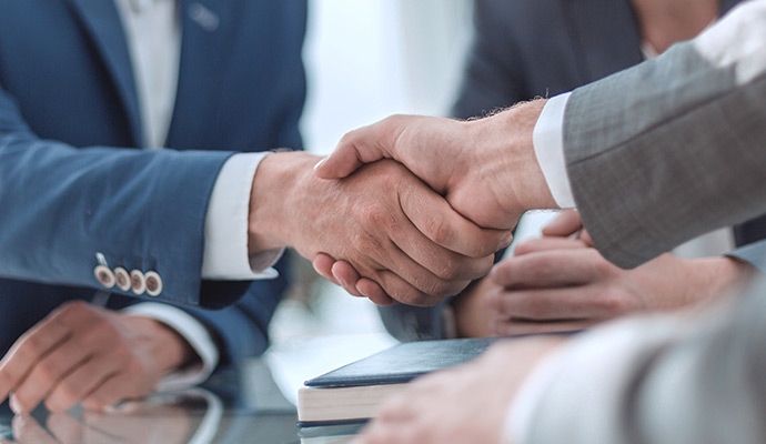 business handshake over table