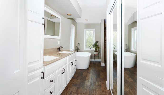 luxury bathroom with double vanity and freestanding tub