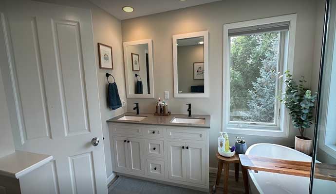 master bathroom interior featuring double vanity and freestanding bathtub