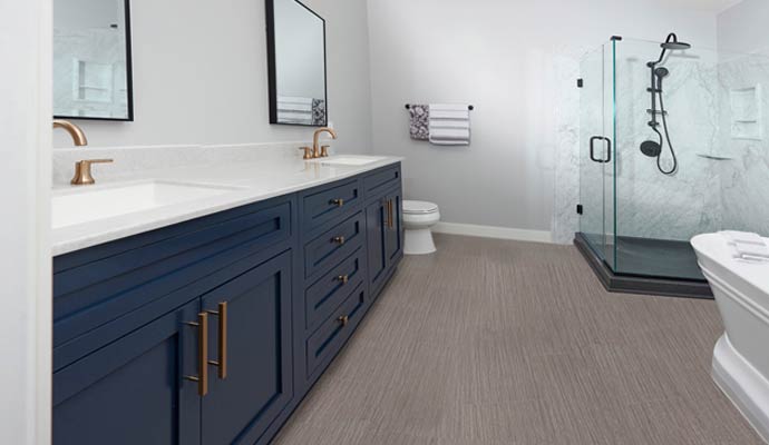 Modern bathroom remodel navy vanity gold fixtures