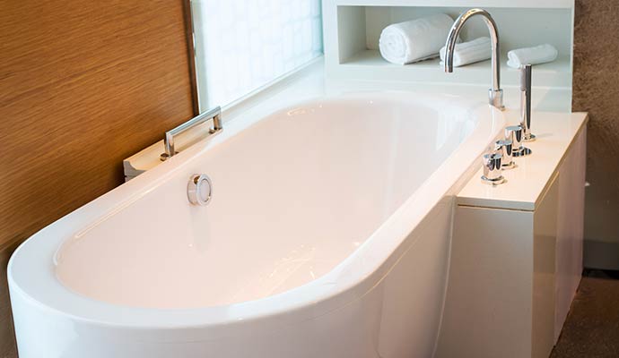 Modern white bathtub surround installed