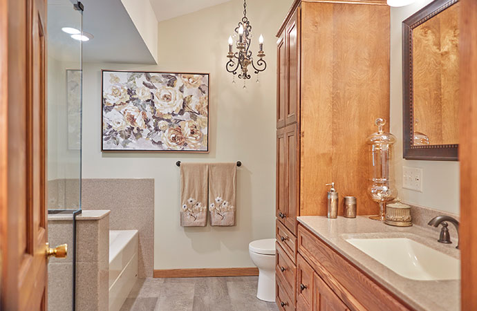 elegant chandelier-lit bathroom with wooden vanity