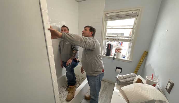 Great Lakes Home Renovations team installing tiles during a bathroom renovation