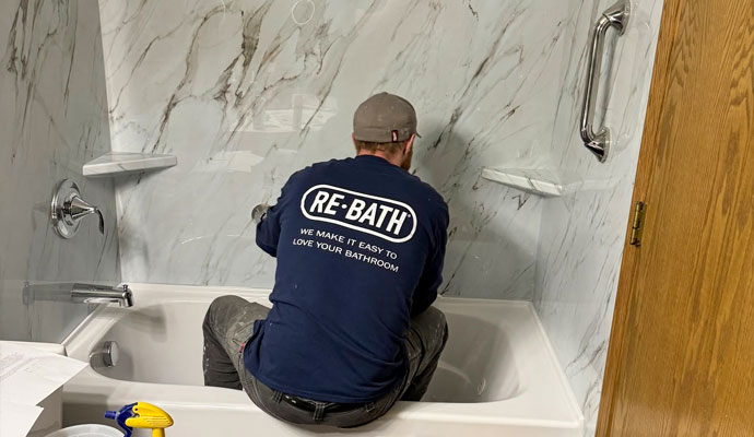 Technician installing bathtub and shower surrounds
